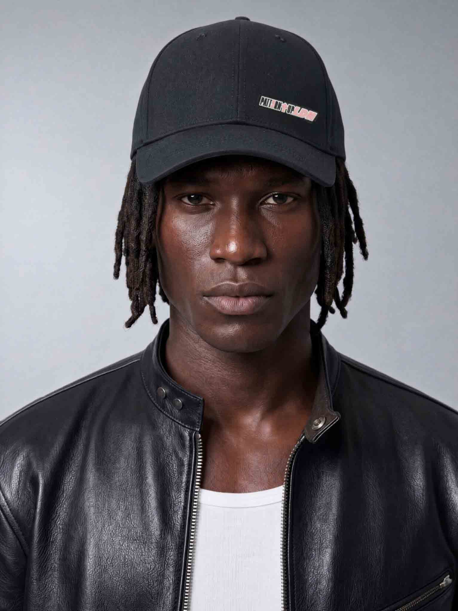 Black satin-lined nylon gym cap designed to reduce frizz, retain moisture and protect hair during workouts